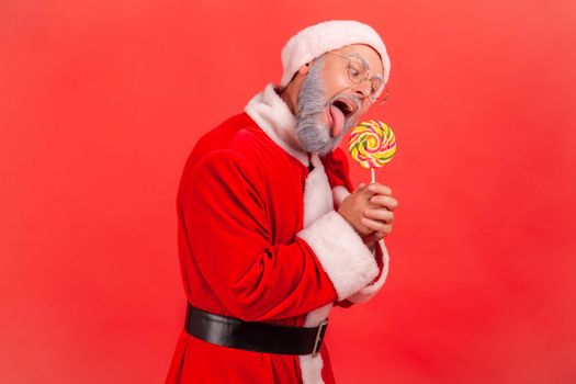Emotional aged santa clause on red background.