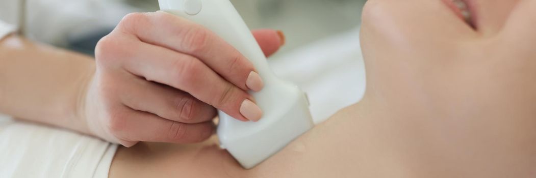 Ultrasound scanning diagnostic for woman of thyroid gland in hospital
