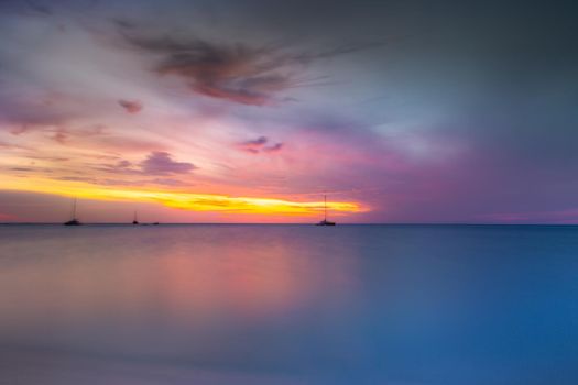 Ships at peaceful sunset on Caribbean sea of Aruba, Dutch Antilles
