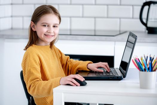 Preteen girl with laptop