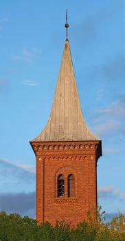 Architecture roof design of church steeple and spire on gothic style cathedral building against blue sky. Tall infrastructure and tower used to symbolise faith and Christian or Catholic devotion
