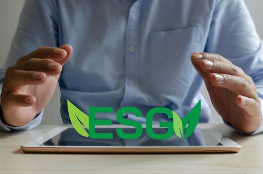 esg green on tablet business concept.