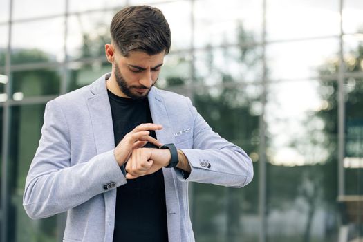 Businessman Scrolling On Display On Smartwatch Notification. Bearded Man Using Smart Watch Wearable Wristband Device. Male Checking Pulse Smartwatch App. Touch Screen Wearable Technology Smart Band
