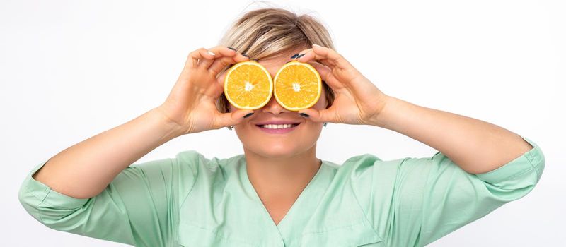 Cosmetologist covering eyes with orange