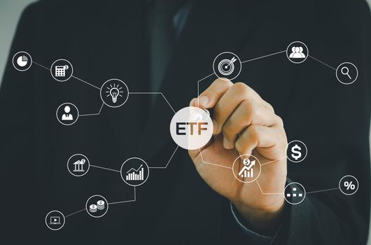 Hand businessman icon ETF Exchange Traded Fund virtual screen Internet Business stock market finance Index Fund Concept. 