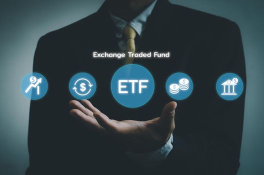 Hand businessman icon ETF Exchange Traded Fund virtual screen Internet Business stock market finance Index Fund Concept. 