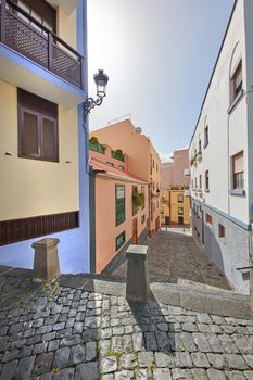 Street view of colorful residential houses or buildings in a quiet alleyway in Santa Cruz, La Palma, Spain. Historical spanish and colonial architecture in a town and famous tourism destination