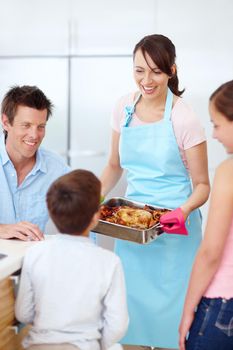 Its your favourite meal, my boy. A beautiful mother presenting a perfectly cooked roast to her excited and ravenous family.