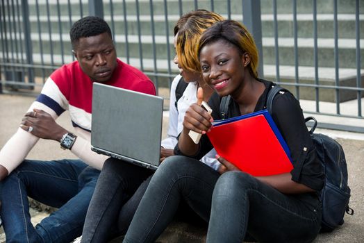 Students studying together on a computer on campus
