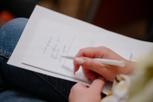 A woman's writing hand.A woman writes in a notebook close-up