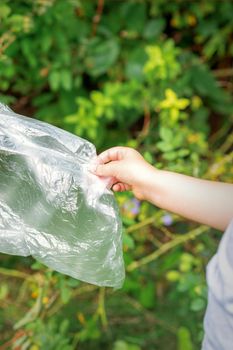Child's hand removes plastic bag