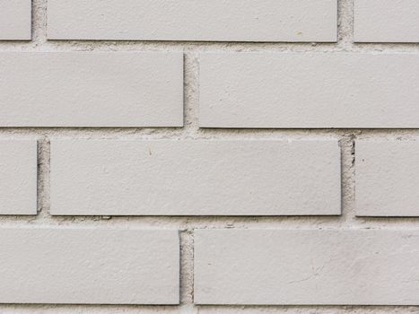 Abstract background of a gray brick wall close-up.
