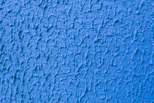 Abstract background of blue embossed rough plaster.