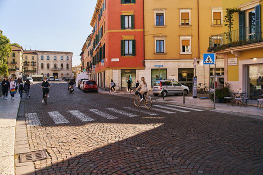 Verona, Italy - October 12, 2021: Sunny cobblestone street in Verona