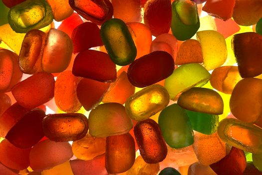 Silhouette of many multi colored yummy bright candies in different shapes.