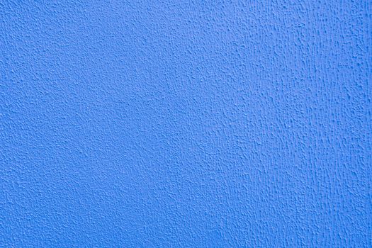 Surface of blue embossed plaster on wall.