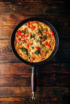 Frittata with broccoli and red pepper in cast iron skillet