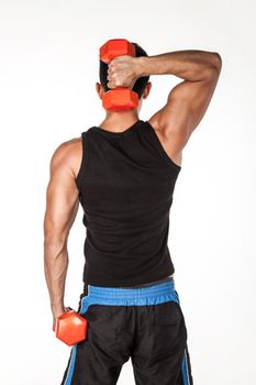 Athletic man in sportswear standing with dumbbells in hands, having workout for biceps and triceps.
