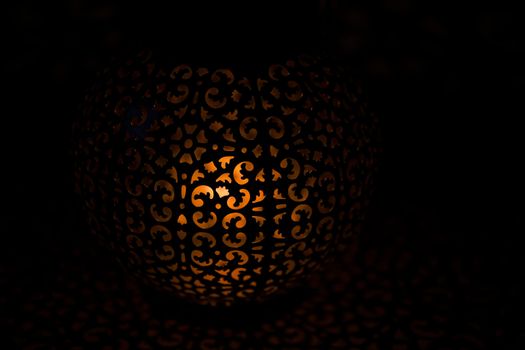Vintage glowing warm lantern in the darkness