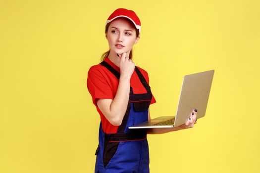 Uncertain worker woman holding laptop, pondering decision, online order for repair services.