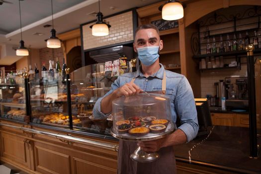 Male confectioner wearing face mask at work