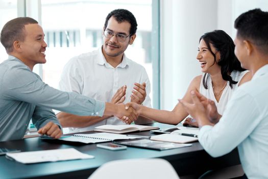 Thrilled to expand their chances of success. businesspeople shaking hands during a meeting in an office.