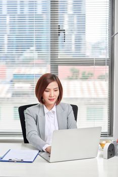 Beautiful young businesswoman in office