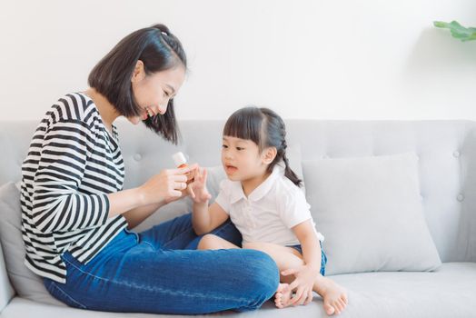 Mother and daughter paint their nails and have fun