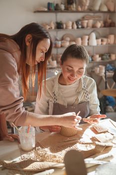 Woman Learning from Professional Potter