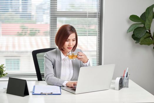 Young female business owner busy working at desk in office