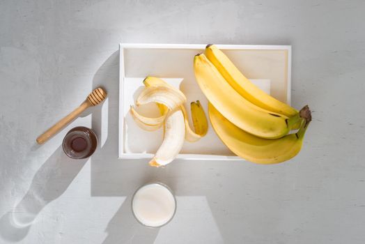 a sliced banana in a bowl on wooden background
