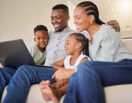 Family is all that matters. a young african family watching movies on a laptop together.