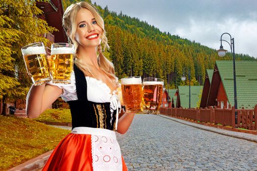 Oktoberfest girl waitress with beer, wearing a traditional Bavarian or german dirndl, serving big mug with drink outdoor. Octoberfest party.