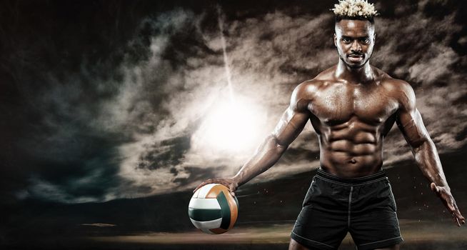 Portrait of afro-american sportsman, beach volleyball player with a ball over sunset. Fit young man in sportswear holding ball.