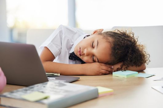 Every boss kid needs their nap. an adorable little girl dressed as a businessperson asleep on her desk in an office.