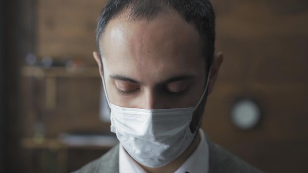 Sad Business Man In Protective Mask Looks Down