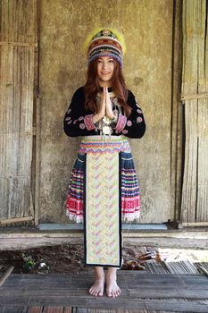 Traditionally dressed Mhong hill tribe woman pay respect