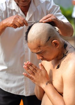 Male who will be monk shaving hair for be Ordained