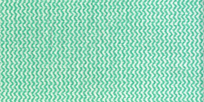 High detail large image of an uncoated tissue paper texture background scan with green and white wave ornament and rough fiber grain napkin high resolution wallpaper