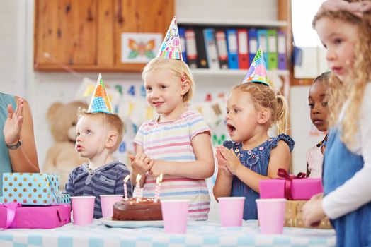 Everyone loves class parties. a preschool children celebrating a birthday in class.