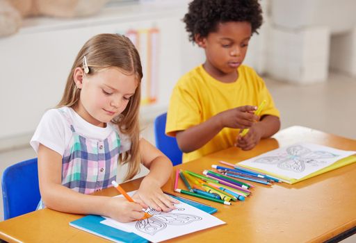 Colouring is a great sitting still activity. preschool students colouring in class.