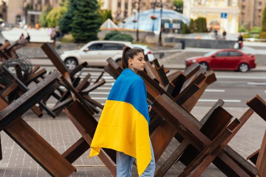 Young woman covered with the Ukrainian flag