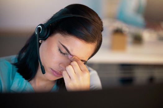 One stressed young caucasian call centre telemarketing agent getting a headache and eye strain while working on computer in office. Female consultant making mistakes and struggling with difficult customers while operating a support helpdesk