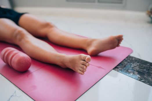 Cropped photo of a woman lying on a yoga mat