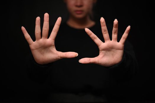 Assertive woman making stop gesture. Expressing security, defense, restriction and negative defensive concept.
