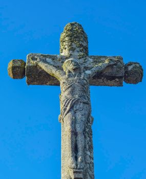 stone cross with crucified Jesus Christ