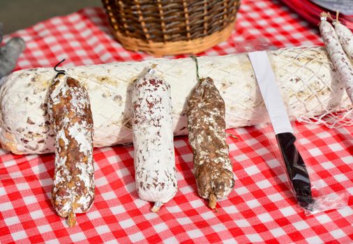 Dried sausage salami in a white packaging