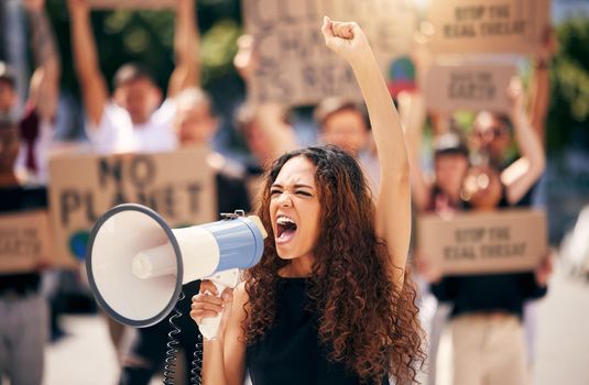 The world is not enough. a young woman shouting into a loudhailer during a protest.