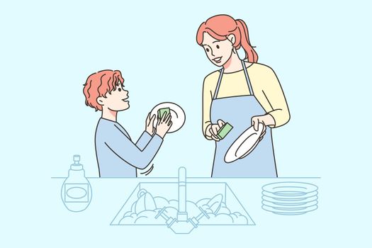 Smiling kid helping mom with dishes