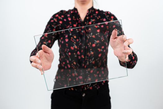 Female Professional Wearing Floral T-Shirt Holding Transparent Glass And Displaying Important Sales Data. Woman With Rectangular Banner Promoting The Company Brand.